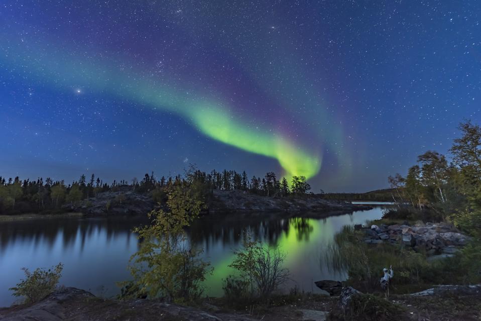 Aurora in twilight at Tibbitt Lake, Yellowknife, Canada.
