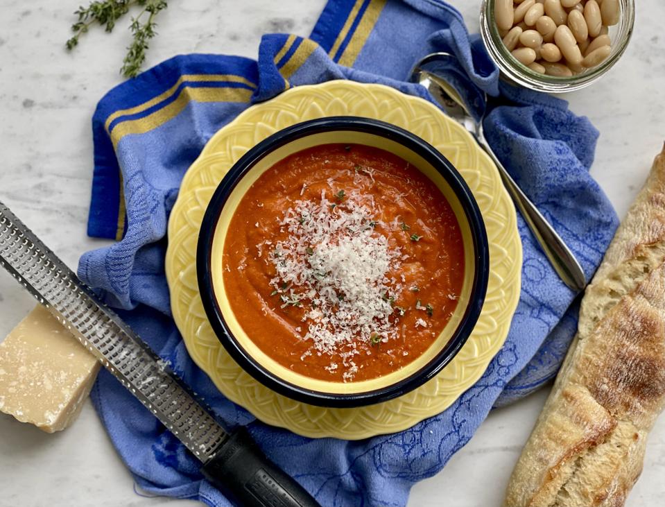 The addition of white beans and cheese turns this simple, humble tomato soup into a meatless meal that sticks to your ribs. In this photo by Elizabeth Karmel is a bowl of tomato and white bean soup topped off with fresh Parmigiano-Reggiano cheese and fresh thyme leaves. 