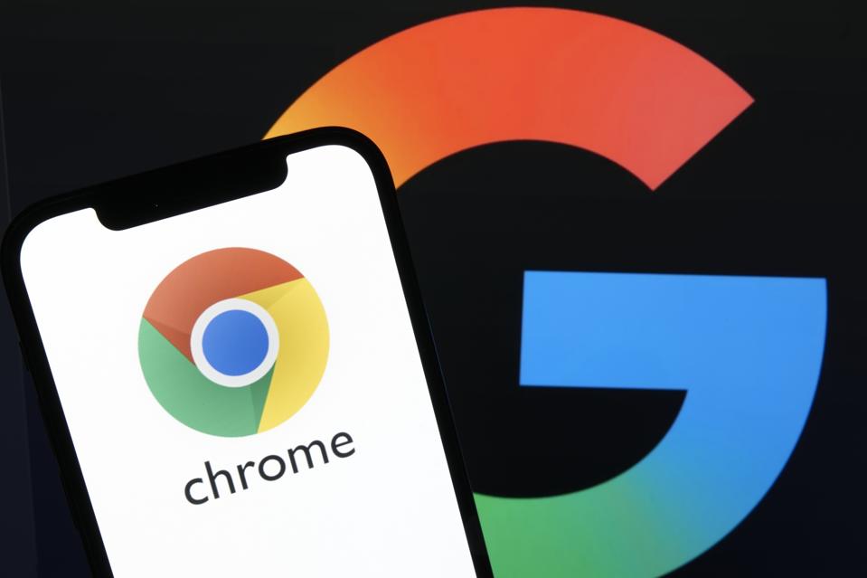 The Google Chrome app icon displays on a smartphone with the Google logo in the background.