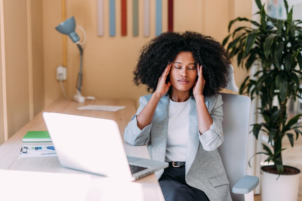 Overworked young businesswoman in the office.
