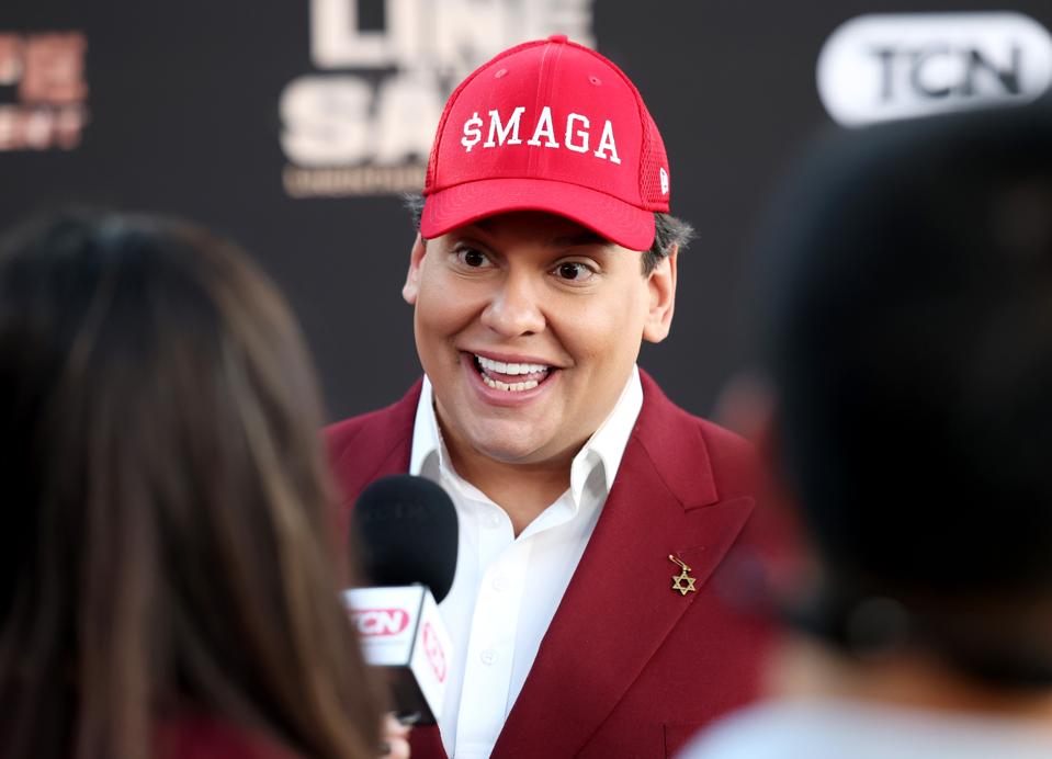 George Santos wearing "$MAGA" hat