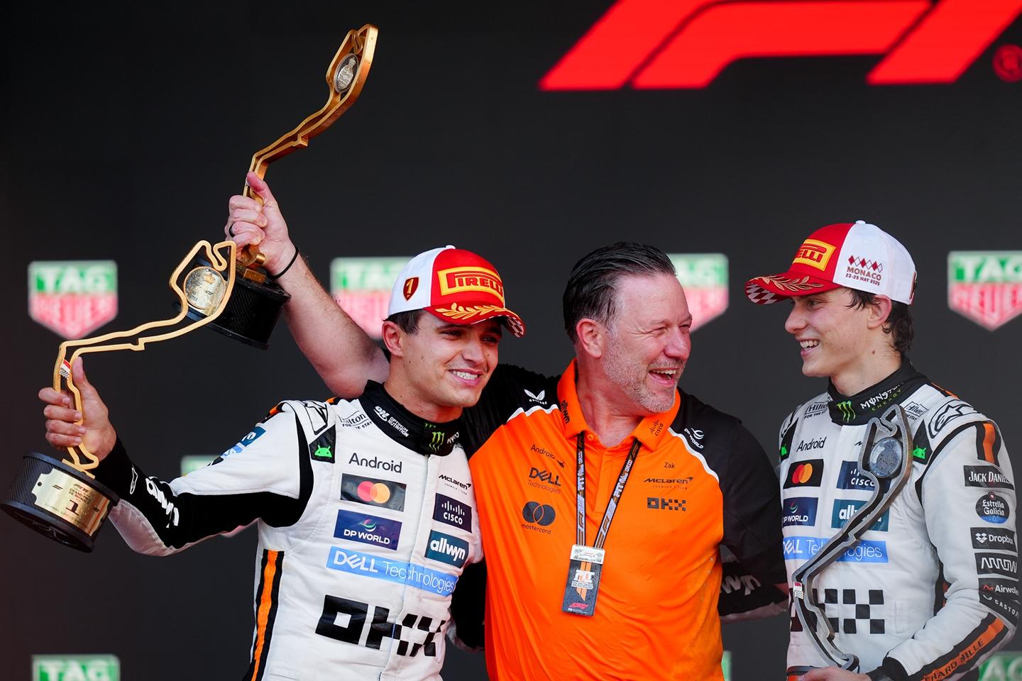 McLaren Racing CEO Zak Brown with drivers Lando Norris and Oscar Piastri.