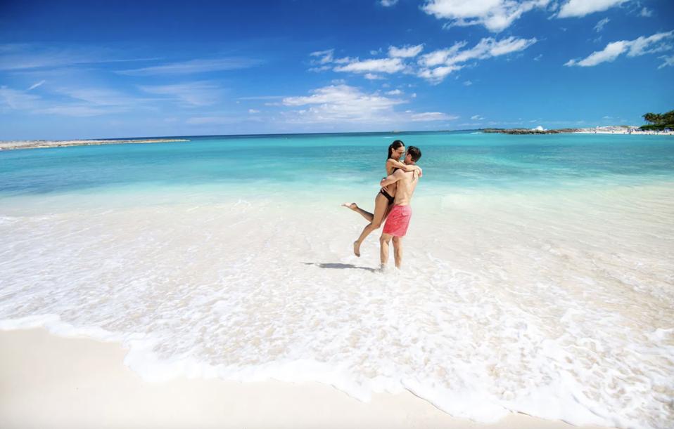 A couple hugging on the beach in the Bahamas