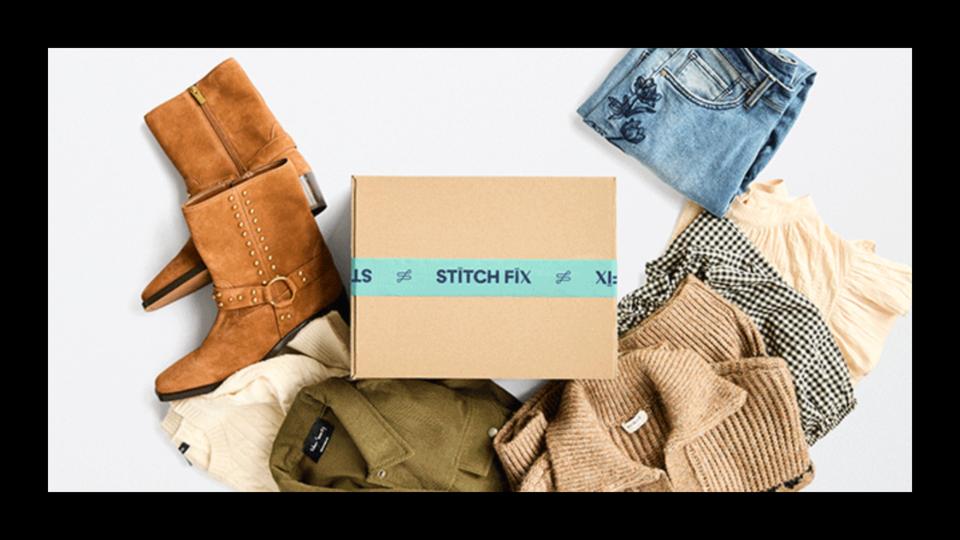 Stitch Fix box surrounded by clothes on a white surface