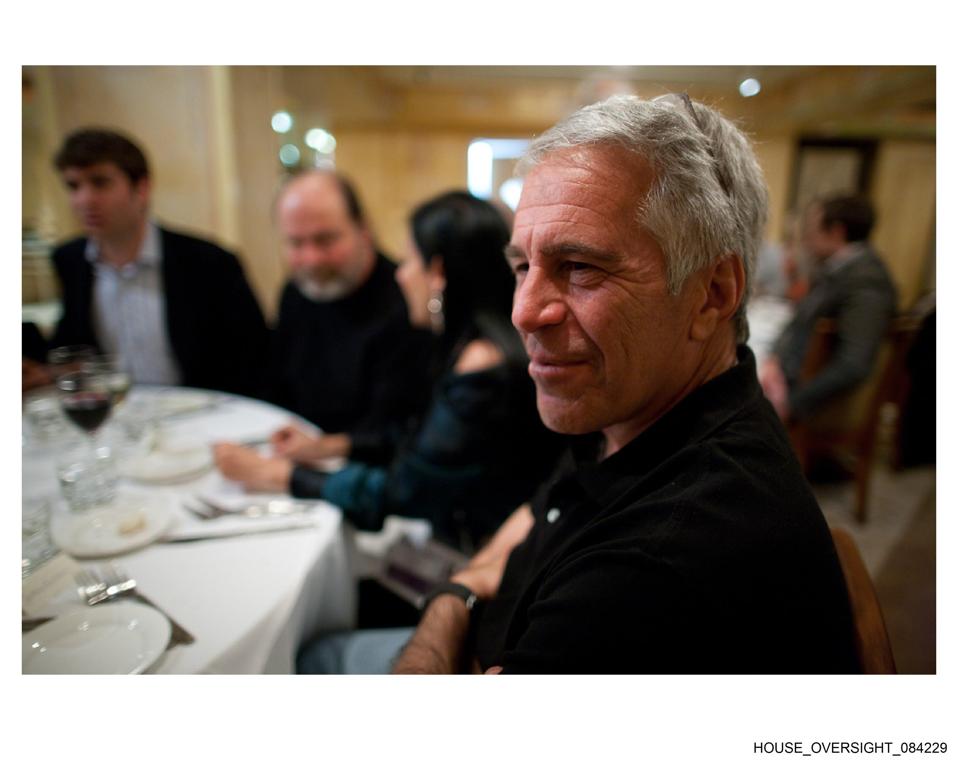 Jeffrey Epstein sitting at table