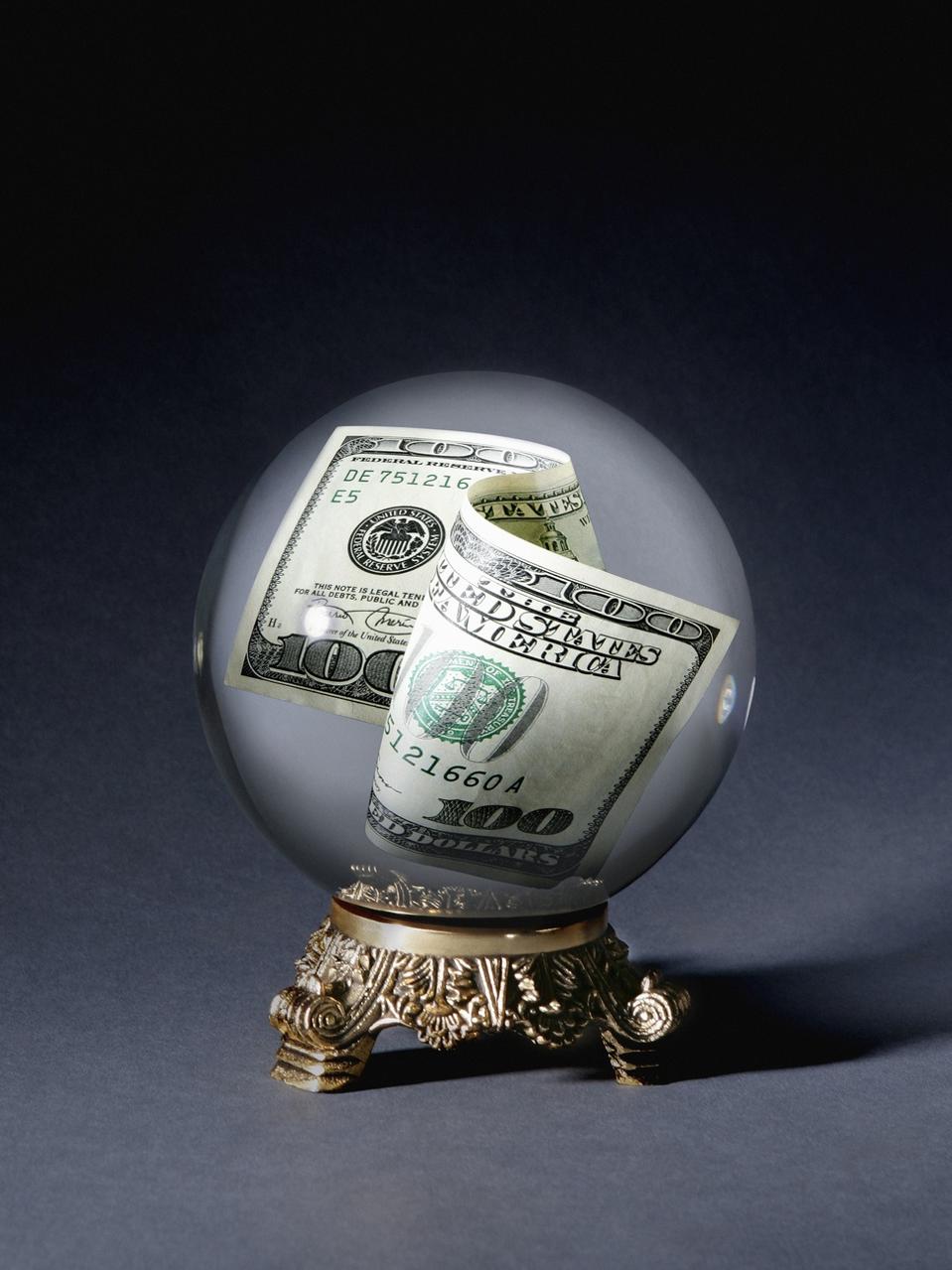 One hundred dollar bill in crystal ball