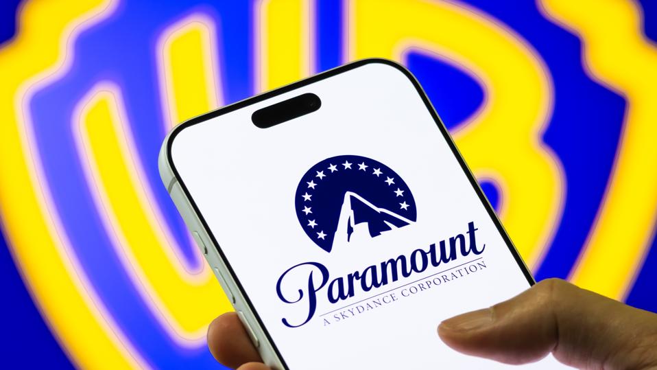 Paramount Logo on Smartphone Against Warner Bros. Discovery Background
