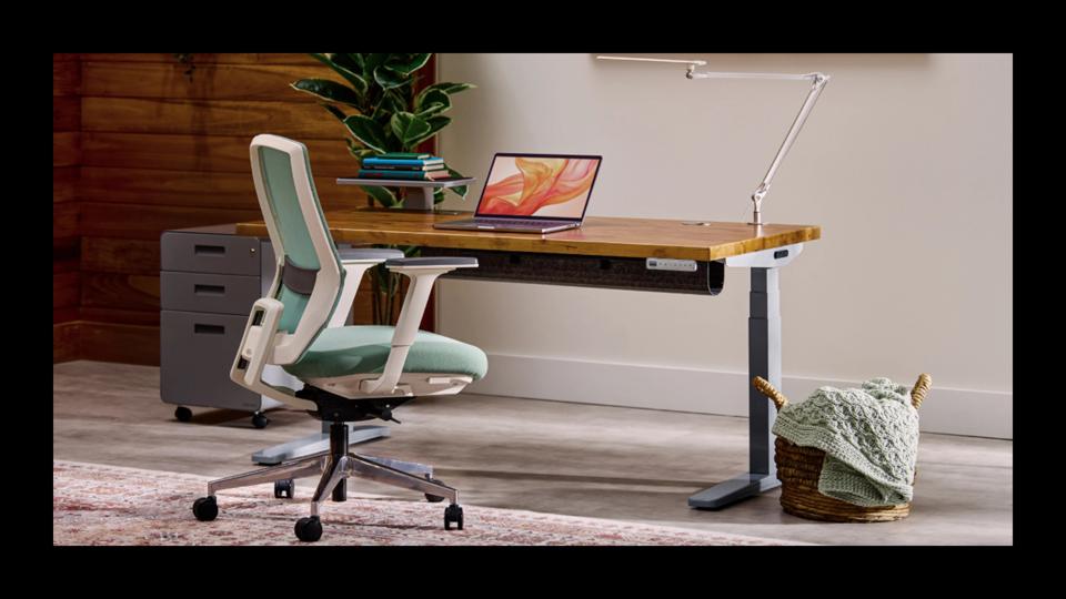 Uplift V3 Standing desk with laptop on top and other accessories attached