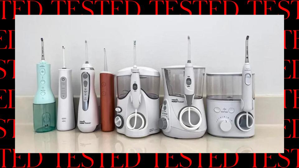 Seven water flossers on a countertop