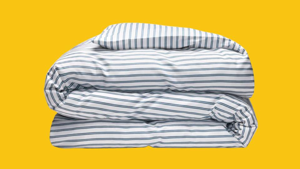 A Brooklinen duvet insert against a yellow background.