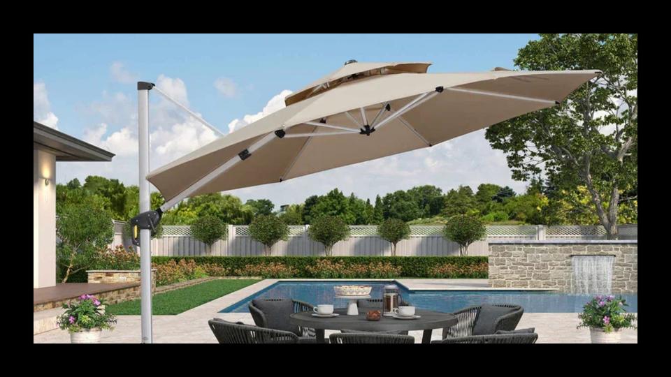 Beige cantilever umbrella over a patio table with pool in the background
