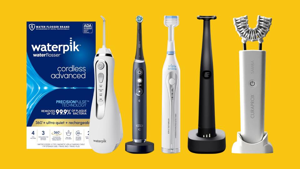 A range of electric toothbrushes, water flossers and floss picks on a yellow background