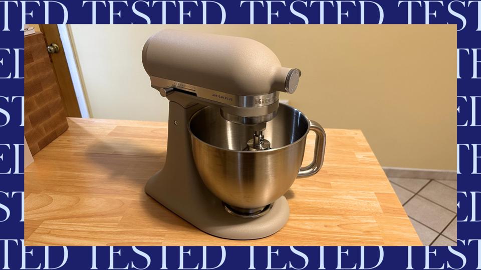 KitchenAid Artisan Plus stand mixer on wood-like countertop