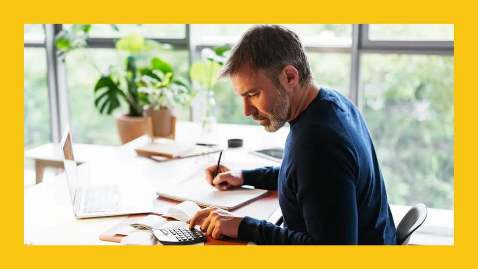 A man at his desk filing taxes with TurboTax.