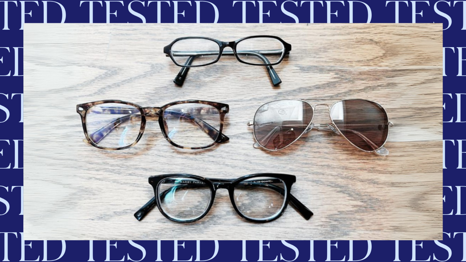 Four prescription glasses on a wooden surface