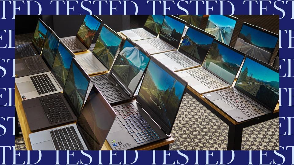 An array of open laptops on tables in a room