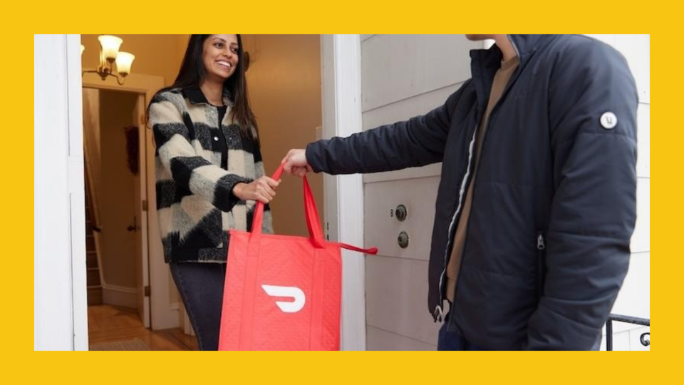 Woman accepting a Doordash delivery at her doorstep.