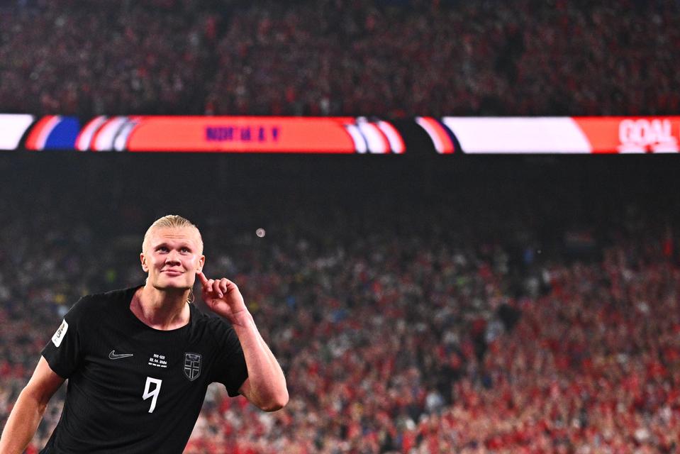 Norway's Erling Halaand holding his finger to his ear in a World Cup match vs. Senegal.