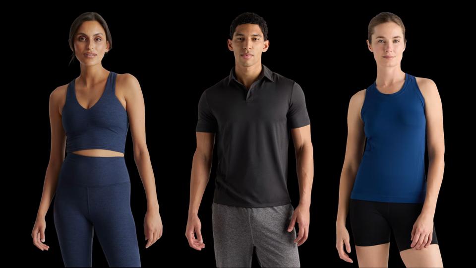 Two female models and one male model wearing Quince clothing.