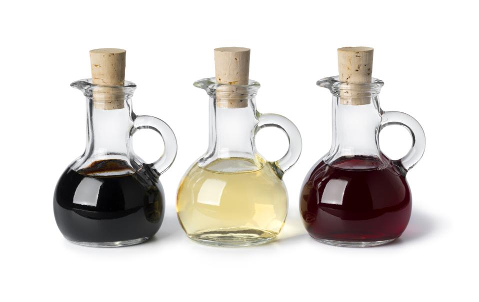 Glass bottles with different types of vinegar