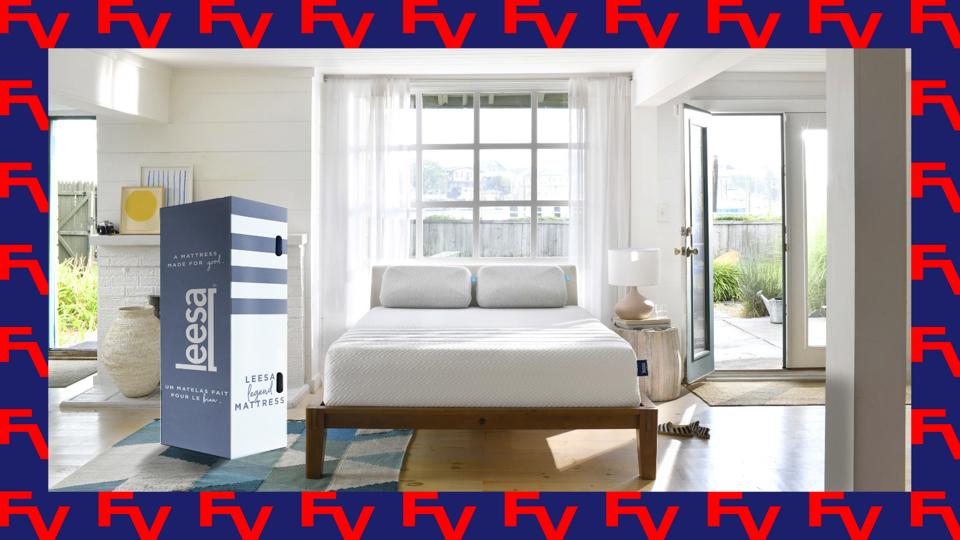 A lifestyle image featuring a Leesa mattress and bed in a spacious bedroom.