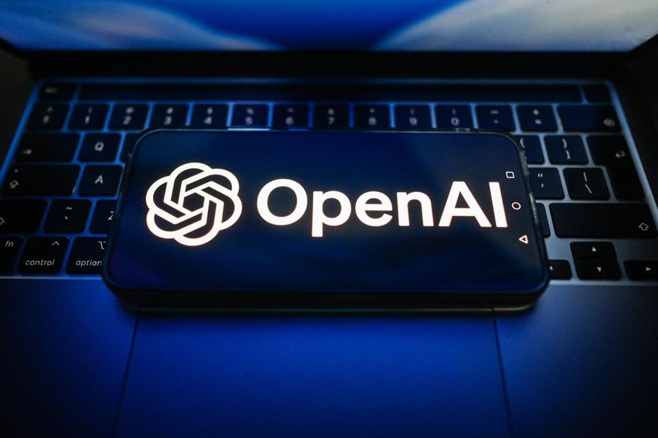 In this photo illustration, an OpenAI logo is seen displayed