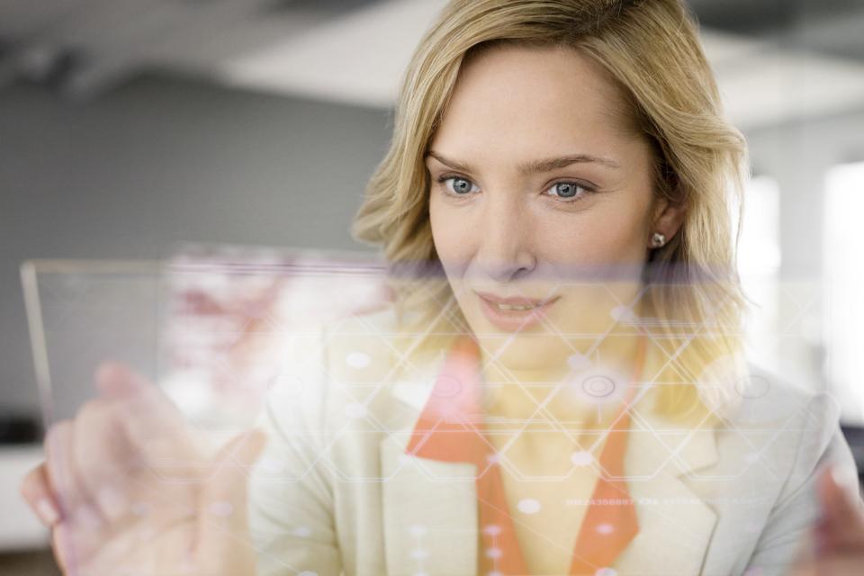 Businesswoman using futuristic portable device