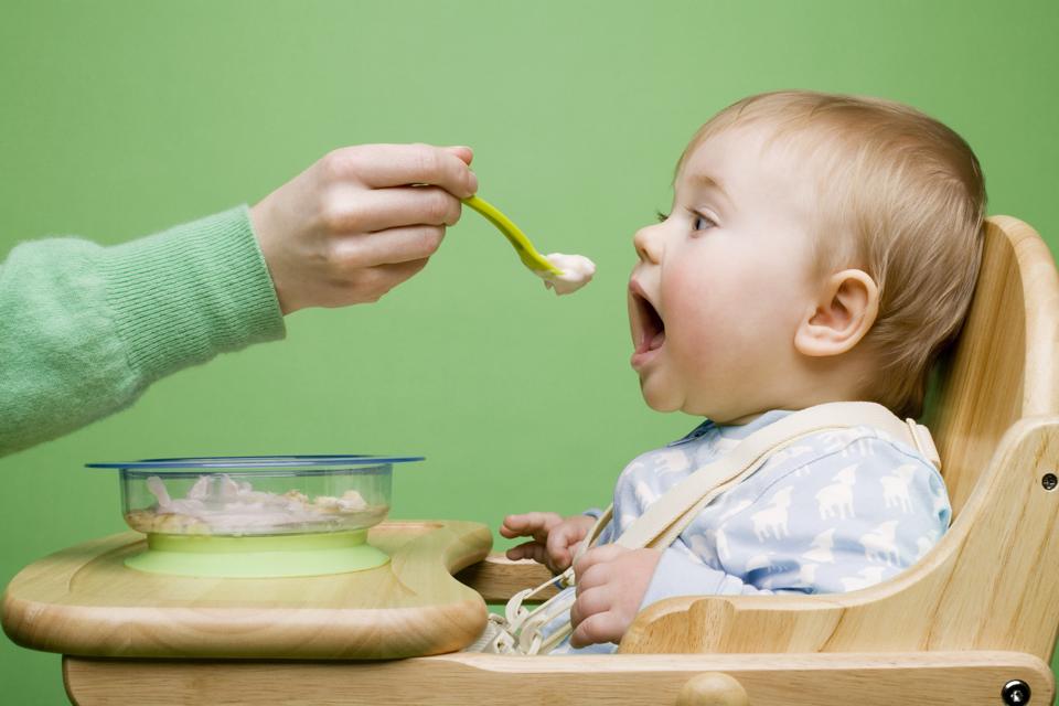 Adult feeding baby