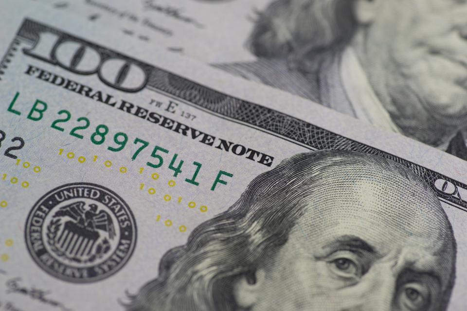 Closed-up image of 100 dollar banknotes. Selective focus technique.