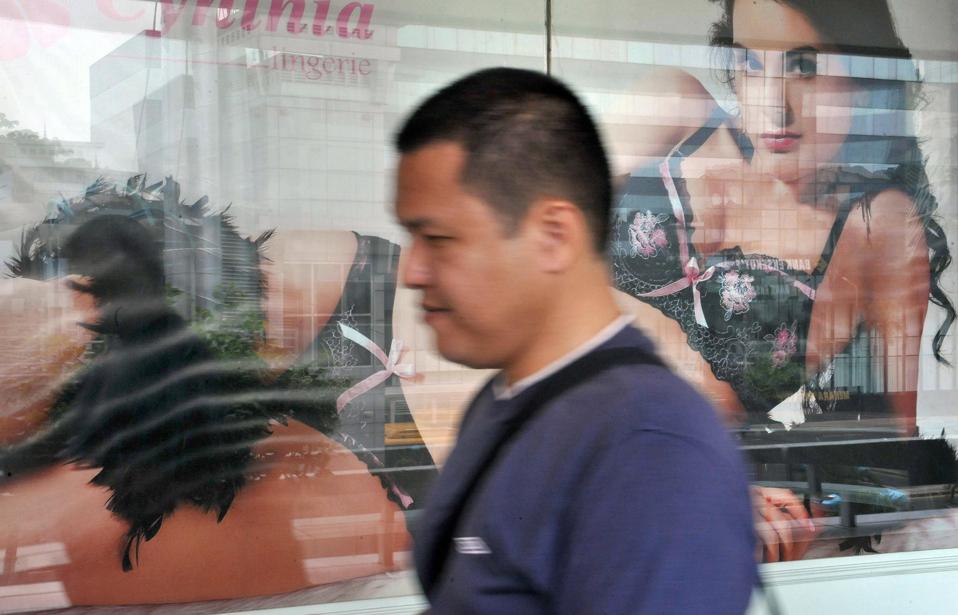 A man walks past a lingerie advertisemen