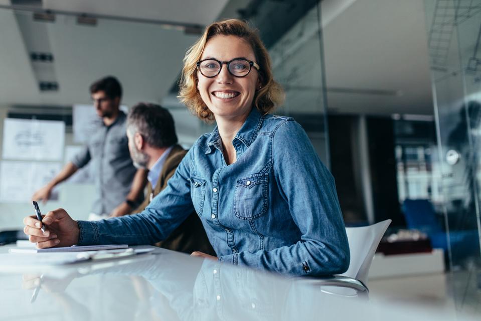 Female designer sitting in board room