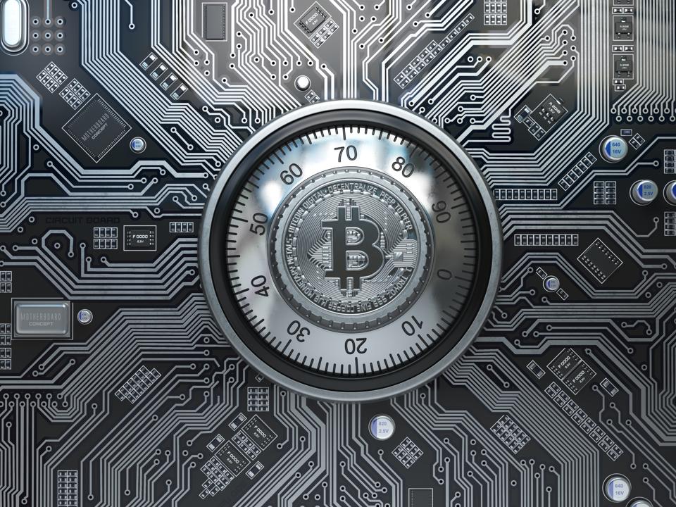 Bitcoin cryptocurrency security and mining concept. Safe lock with symbol of bitcoin on circuit board.