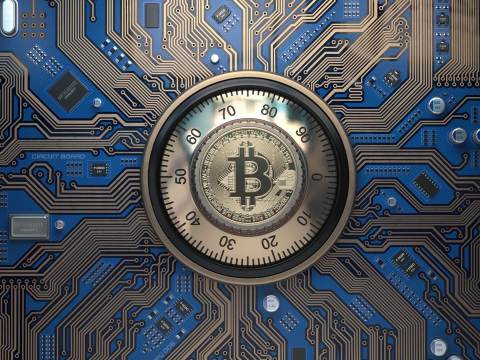 Bitcoin cryptocurrency security and mining concept. Safe lock with symbol of bitcoin on circuit board.