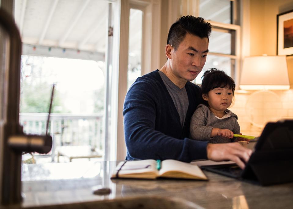 Father working in kitchen with daughter