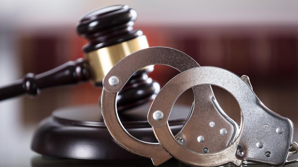 Close-up Of Handcuffs And Gavel