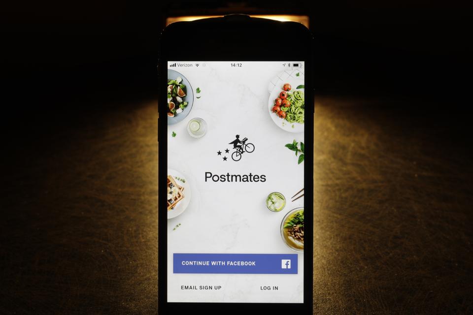 Postmates app on an iPhone. AP Photo/Charles Rex Arbogast