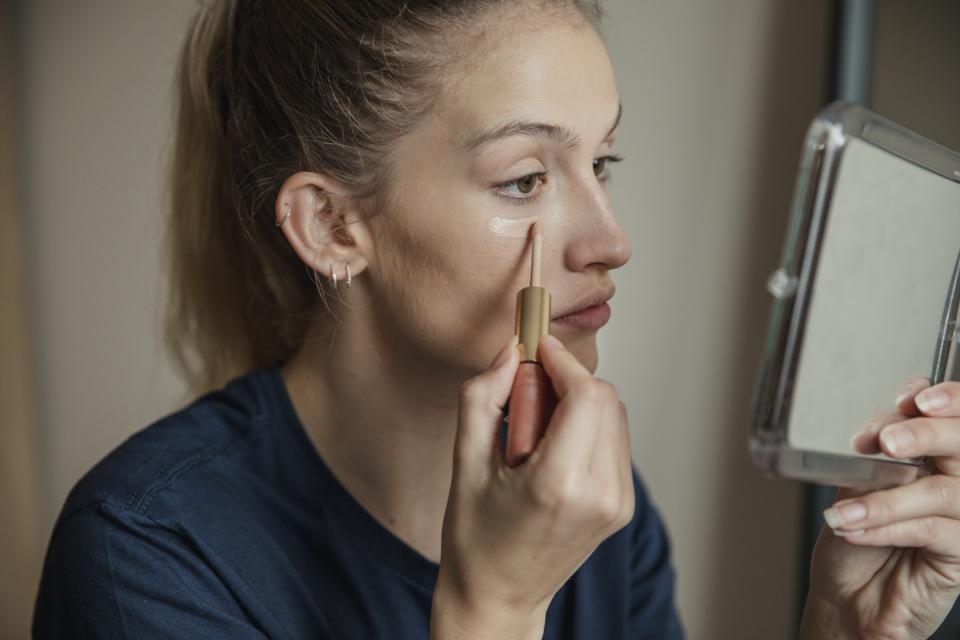 Applying Make-up to Under her Eyes