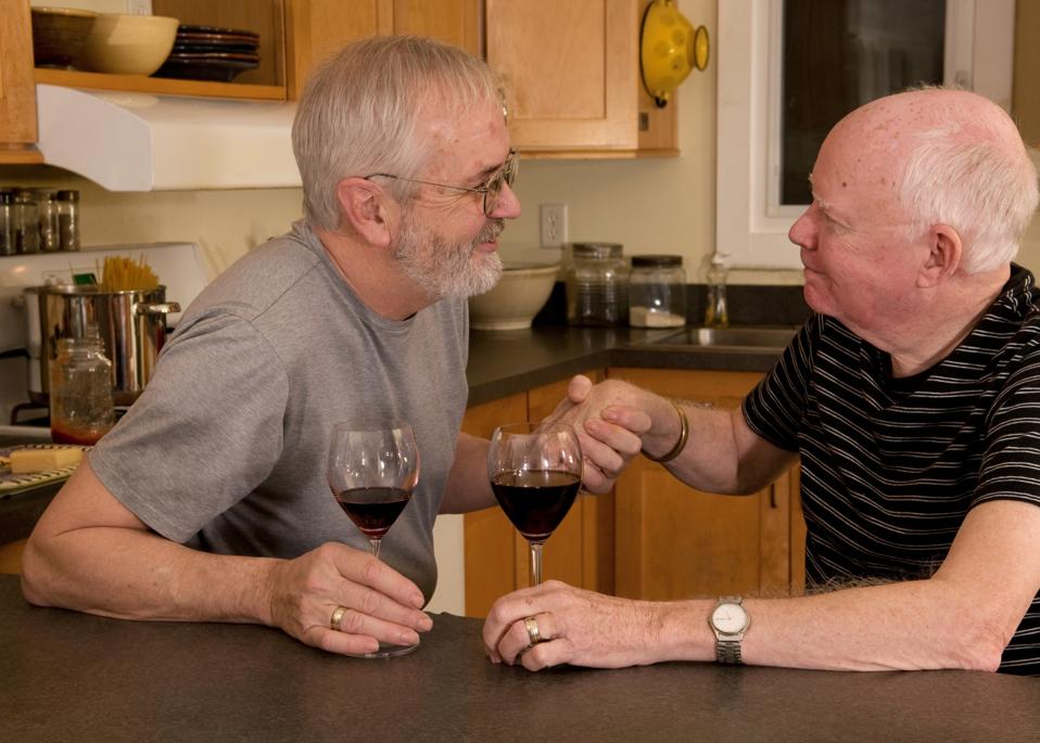 Mature gay couple having wine