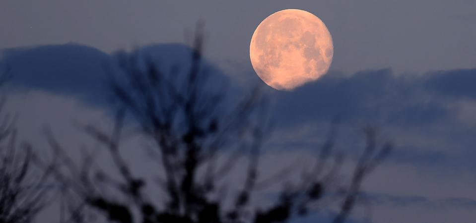 A nearly full moon sets over Langenhagen, Germany.