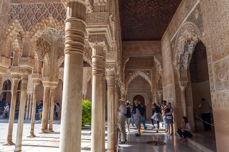 Columns line the Patio de los Leones in the Alhambra, a 13th...