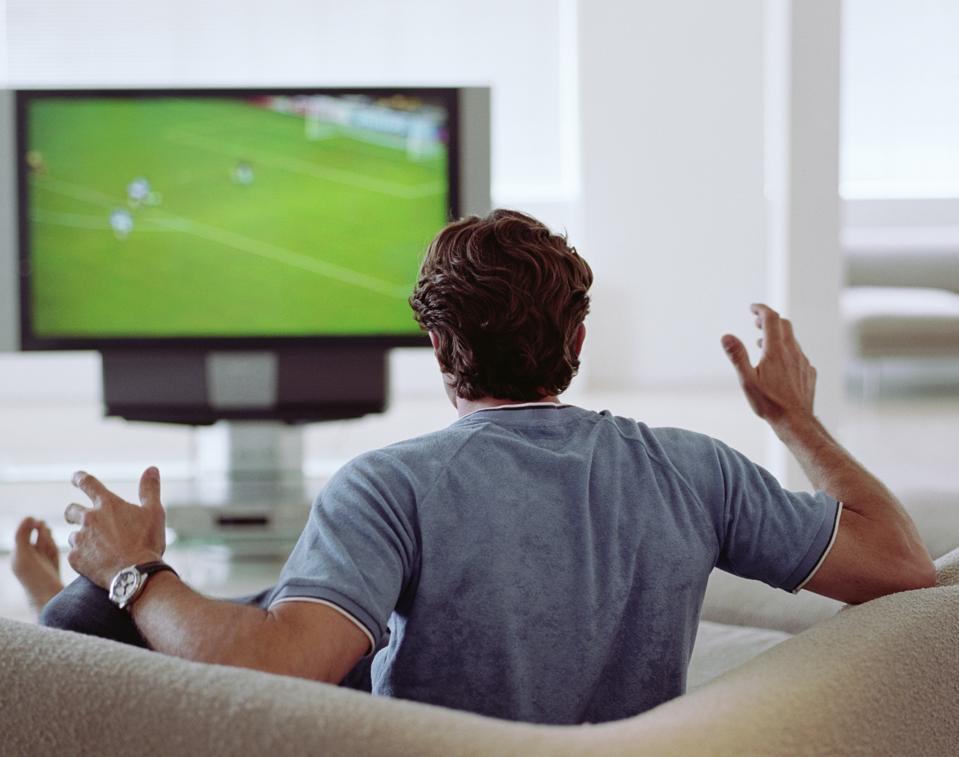 Man watching football on television.