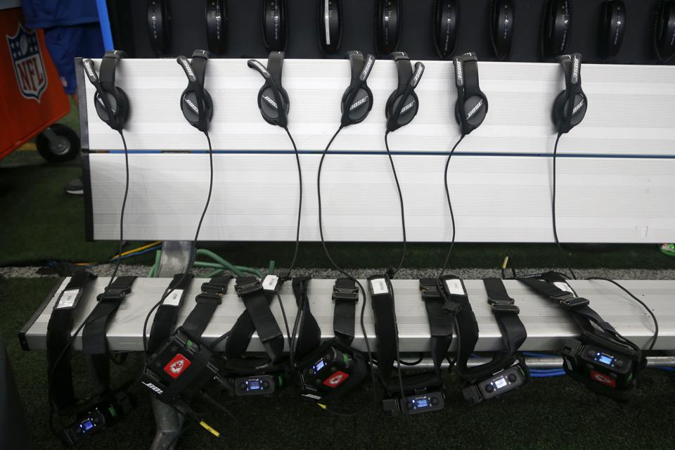 Bose headsets and radios sit on a bench before an NFL football game. Photo: Michael Ainsworth.