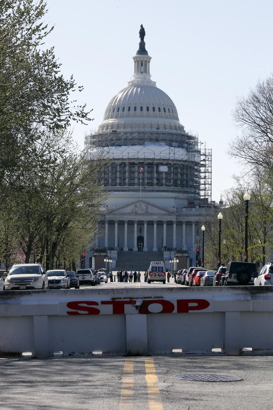 The US Capitol with a raised barricade blazoned with the words "stop." (AP Photo/Alex Brandon)